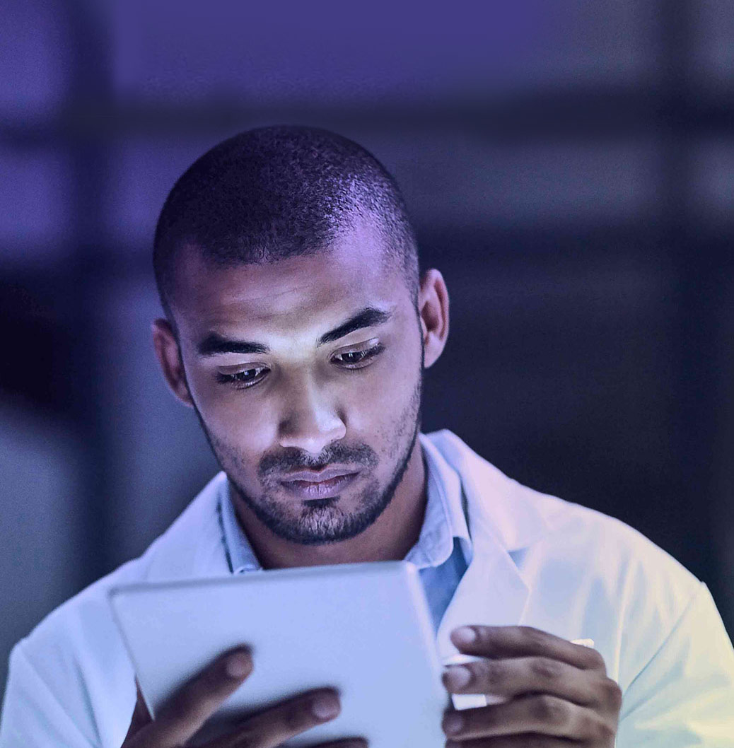 Scientist in a lab coat focused on a tablet, symbolizing modern scientific research and technology use