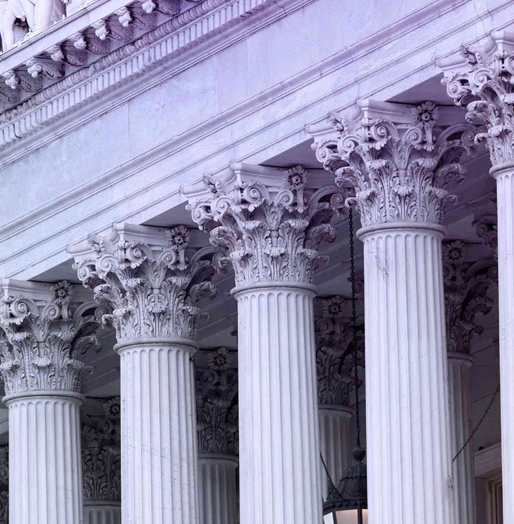 Ornate classical columns of a grand building, symbolizing strength, stability, and architectural elegance.